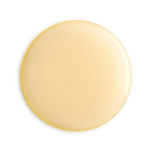 Round beige apricot oil droplet on a white background
