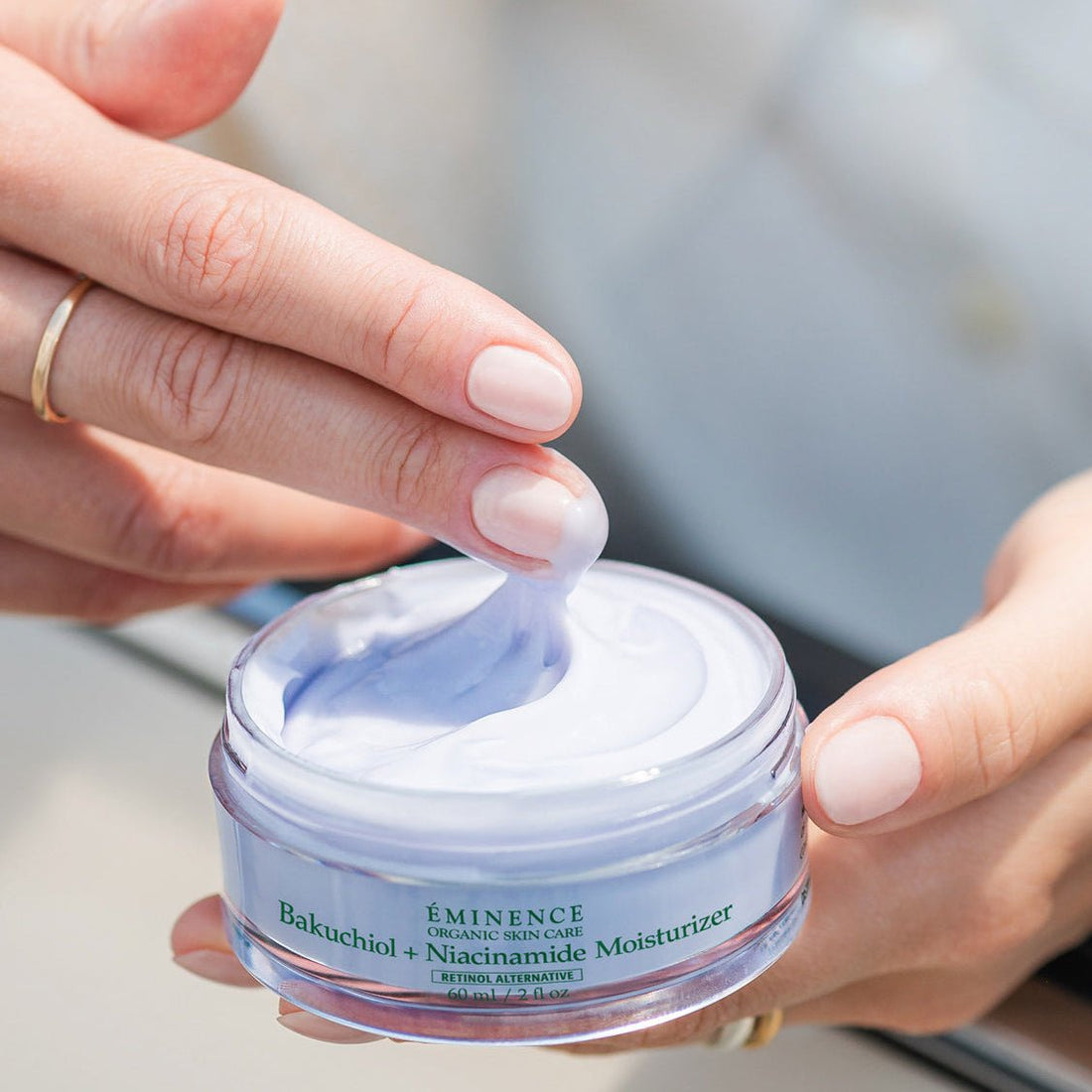 Person applying Eminence Balchuchid + Niacinamide Moisturizer to their hand - okotoks hc pharmacy