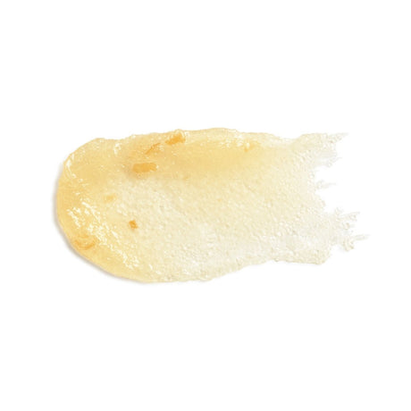 A smear of pale yellow cream or gel cosmetic product on a plain white background. - okotoks hc pharmacy