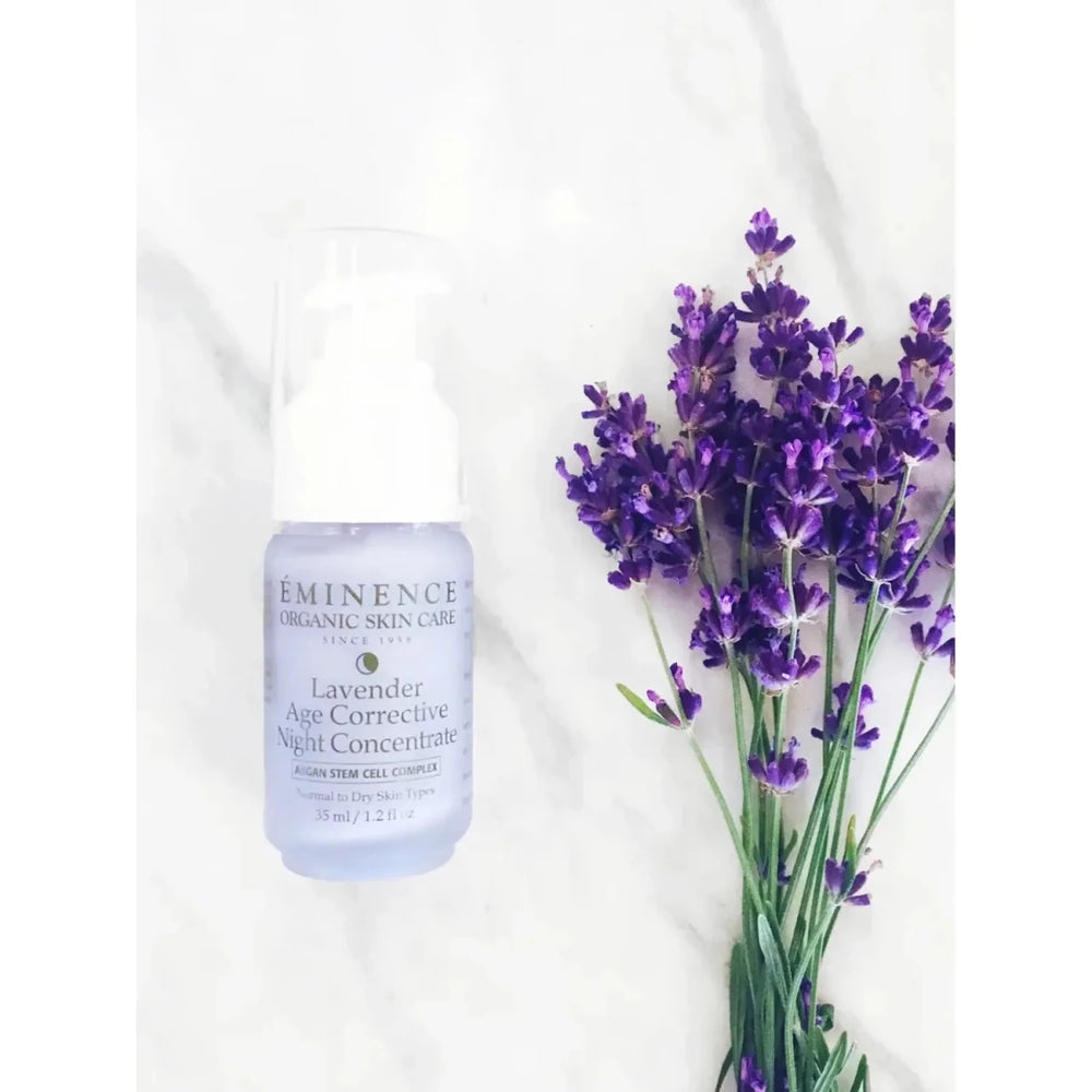 Eminence Lavender Age Corrective Night Concentrate bottle with lavender flowers on a white background