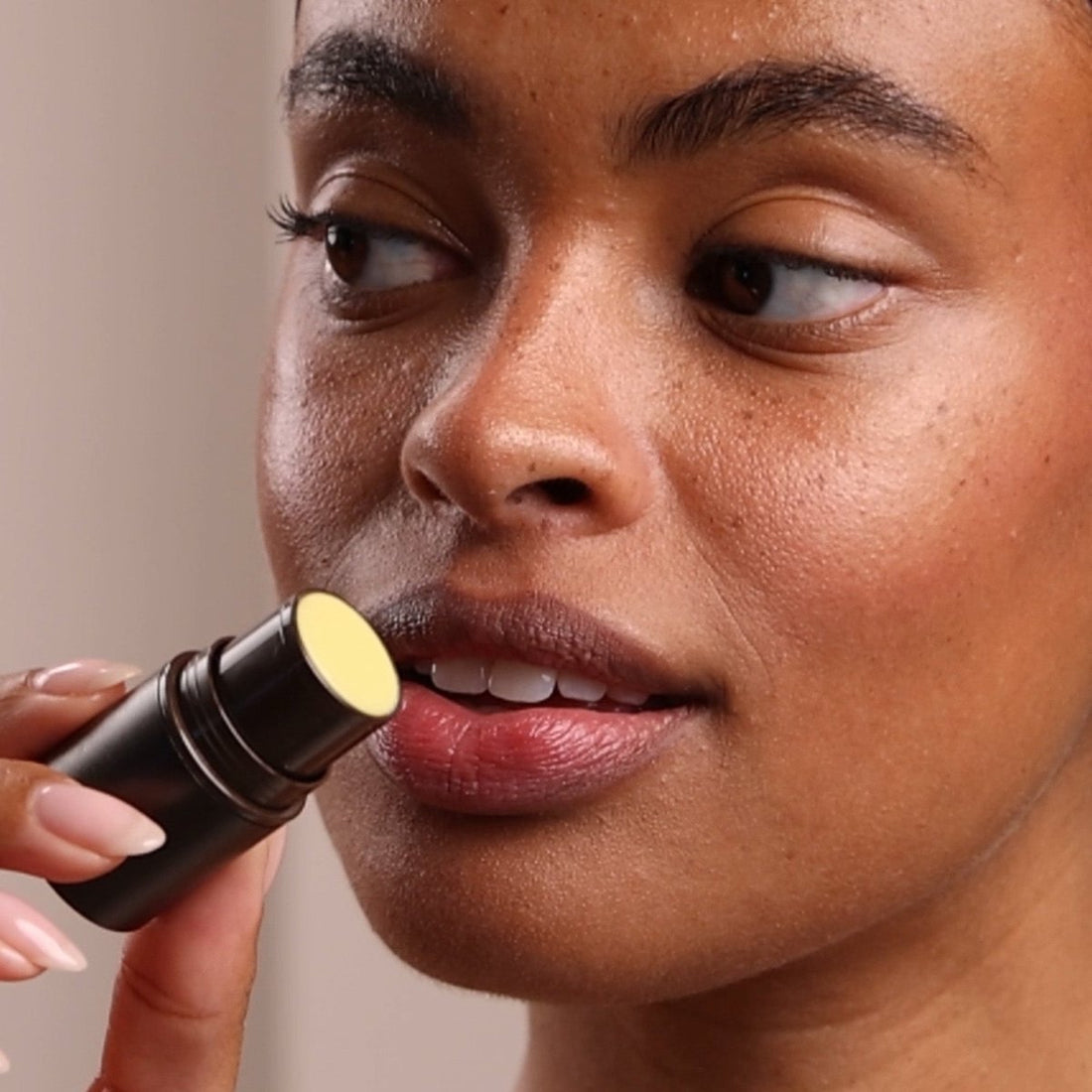 Person applying lipstick with a focus on the action - okotoks hc pharmacy