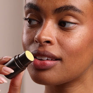 Person applying lipstick with a focus on the action - okotoks hc pharmacy