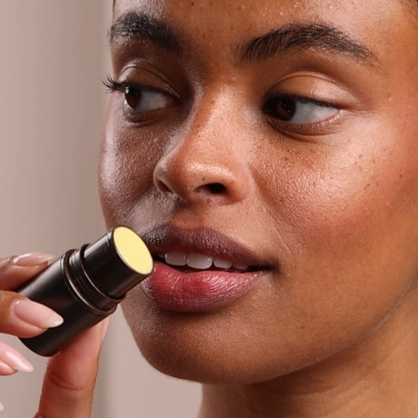 Person applying lipstick with a focus on the action - okotoks hc pharmacy