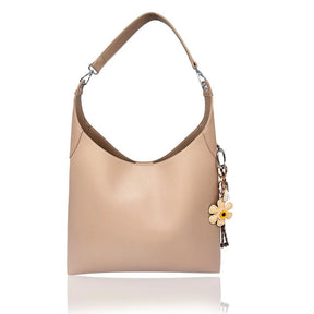 Beige handbag with a flower charm on a white background - okotoks hc pharmacy