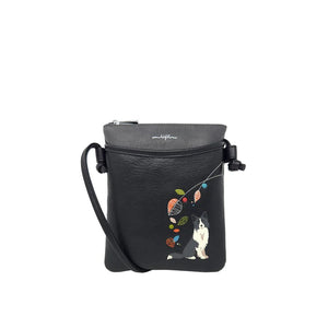 Black crossbody bag with a dog and colorful leaves design on a white background - okotoks hc pharmacy
