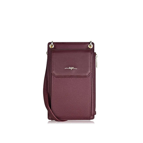 Purple crossbody bag with a visible brand logo on a white background - okotoks hc pharmacy