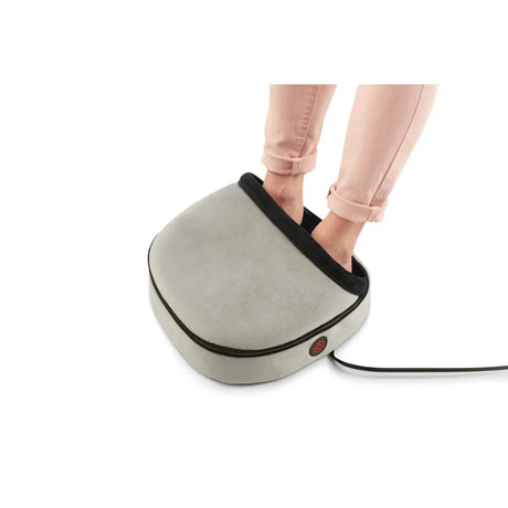 Person using a foot massager on a white background - okotoks hc pharmacy