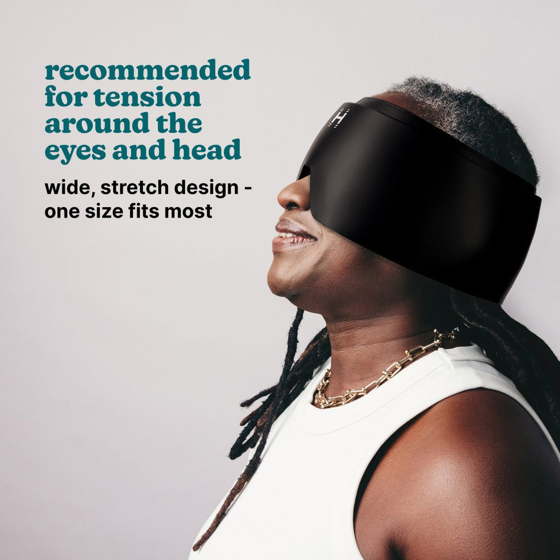 Person wearing a black head mask with text about its use for tension around the eyes and head. - okotoks hc pharmacy