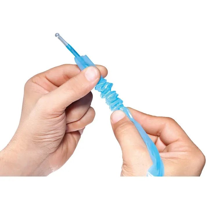 A close-up of a person's hands holding and stretching a translucent blue silicone sleeve or tube against a plain white background. - okotoks hc pharmacy