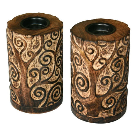 Two wooden candle holders with intricate carvings on a white background - okotoks hc pharmacy
