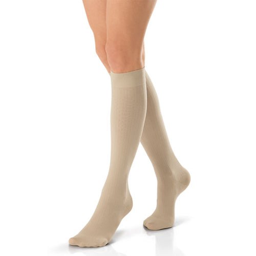 Beige knee-high socks worn by a person on a white background - okotoks hc pharmacy