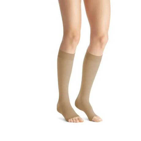 Beige knee-high socks worn by a person on a white background - okotoks hc pharmacy