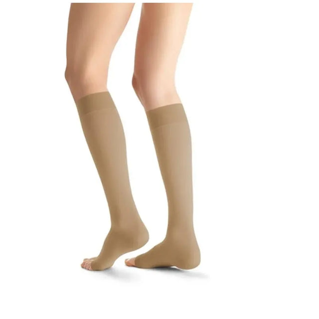 Beige knee-high socks worn by a person on a white background - okotoks hc pharmacy