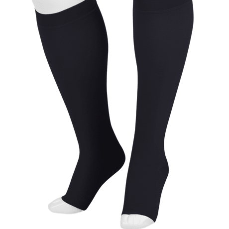 Black knee-high compression socks shown on a white mannequin leg form against a plain white background.  -okotoks hc pharmacy
