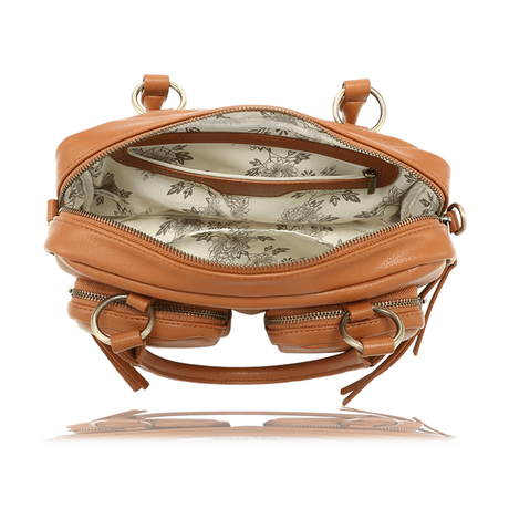 A tan leather shoulder bag shown open from the front, displaying its interior with a floral toile-patterned lining, multiple zippered compartments, and gold-tone hardware. - okotoks hc pharmacy