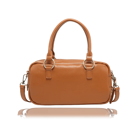 A tan leather handbag with double top handles, gold-tone hardware, and a detachable shoulder strap, shown against a plain white background with a soft reflection below. - okotoks hc pharmacy