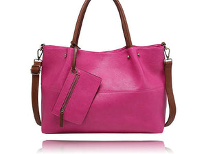 A bright pink pebbled leather tote bag with brown leather handles, a detachable shoulder strap, and a matching zippered pouch, shown on a white background with a reflection. - okotoks hc pharmacy