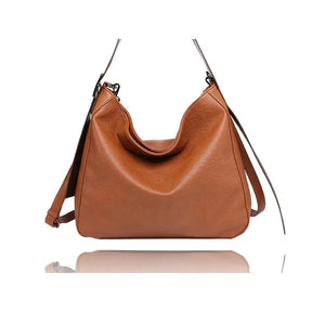 Brown leather handbag with a strap on a white background - okotoks hc pharmacy