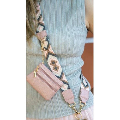 Pink wallet with a patterned strap worn by a person - okotoks hc pharmacy