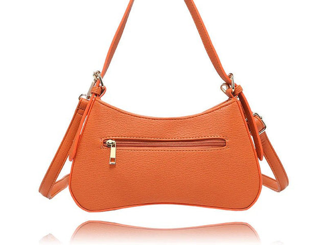 An orange pebbled faux-leather shoulder bag with a curved crescent shape, featuring a front zippered pocket with a gold-tone zipper pull and a matching adjustable shoulder strap, shown on a white background with a reflection below. - okotoks hc pharmacy