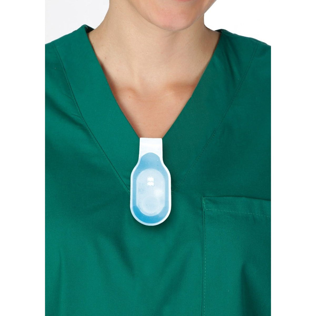 Person wearing a green scrub top with a blue and white medical device on a white background - okotoks hc pharmacy