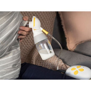 Person using a breast pump, with a blurred background. - okotoks hc pharmacy