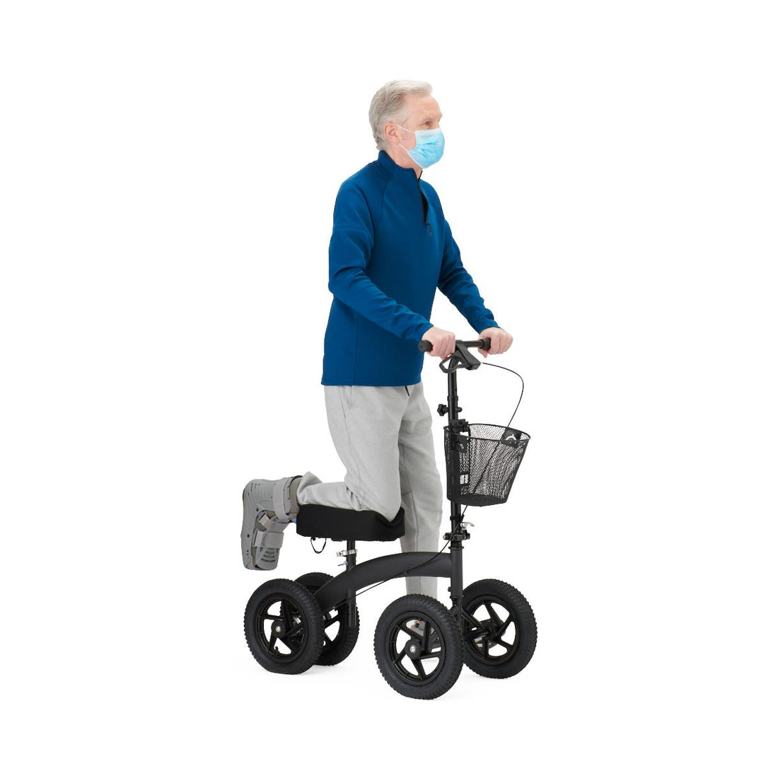 Person using a knee walker with a basket on a white background - okotoks hc pharmacy