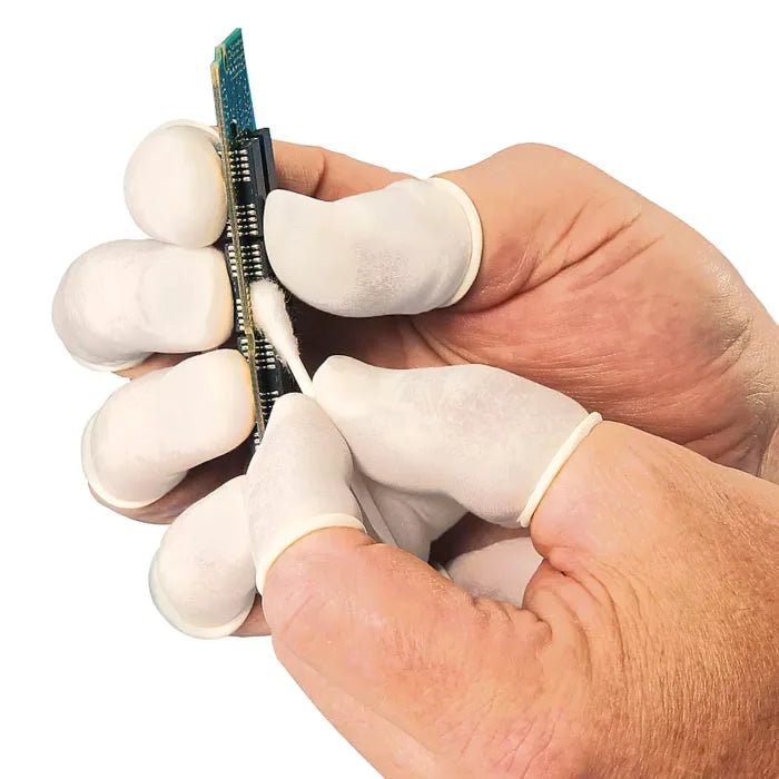 Hand wearing a white glove holding a small electronic component on a white background - okotoks hc pharmacy