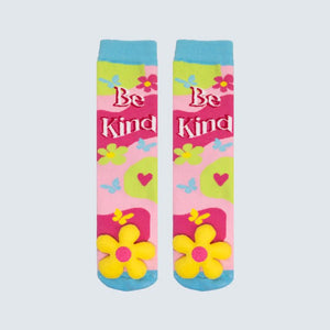 Colorful socks with 'Be Kind' text and floral designs on a light gray background - okotoks hc pharmacy