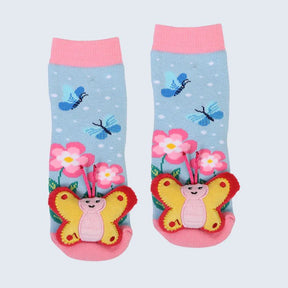 Pair of children's socks with butterfly and flower design on a light blue background - okotoks hc pharmacy