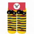 A pair of children's novelty socks in yellow and gray stripes with cartoon cars, shown hanging from a red 'Messy Moose Socks' retail hanger. The socks feature black car-shaped heels and toes with white wheels, and smaller multicolored cars printed along the sides. - okotoks hc pharmacy