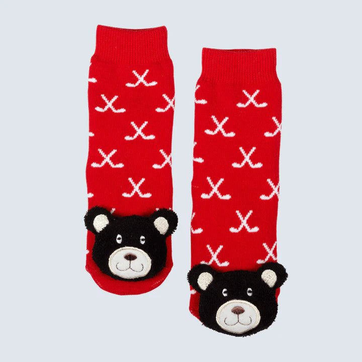 Red socks with bear faces and white patterns on a light gray background - okotoks hc pharmacy