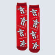 Red socks with white Inukshuk designs and 'Canada Rocks!' text on a light gray background - okotoks hc pharmacy
