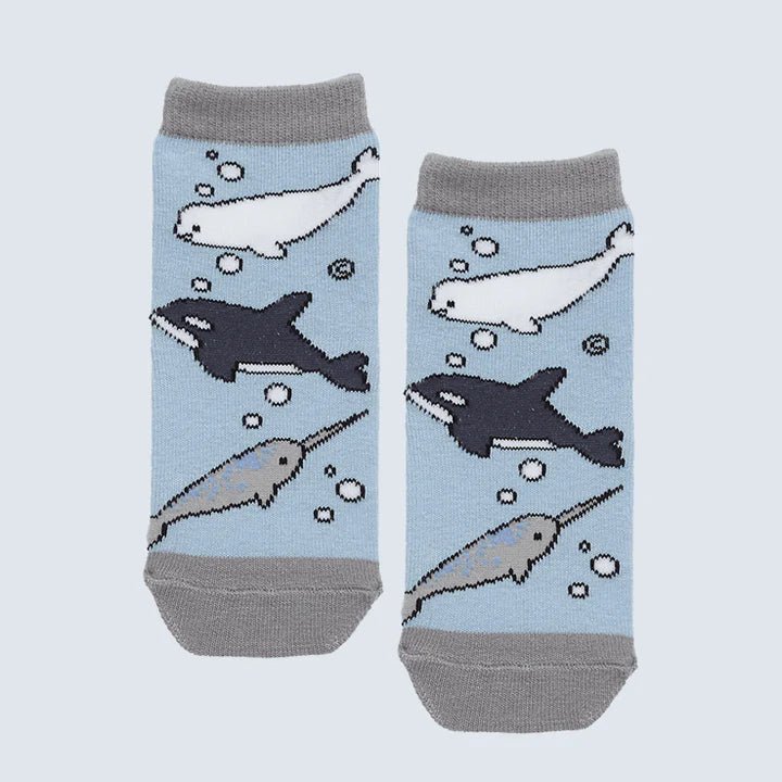 Pair of socks with whale and narwhal patterns on a light blue background - okotoks hc pharmacy