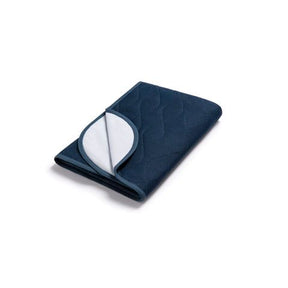 Folded navy blue underpad with white interior on a white background - okotoks hc pharmacy