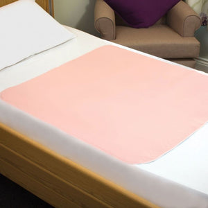 Pink mattress topper on a bed with a blurred background - okotoks hc pharmacy