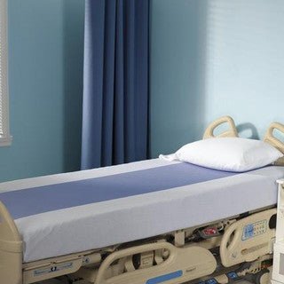 Hospital bed in a room with blue walls and a curtain. - okotoks hc pharmacy