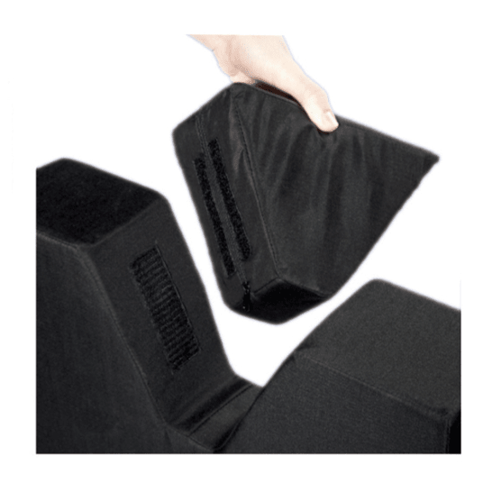 A hand lifting one of three black adjustable foam wedge support blocks against a plain white background. - okotoks hc pharmacy