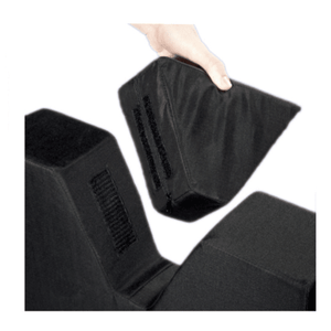 A hand lifting one of three black adjustable foam wedge support blocks against a plain white background. - okotoks hc pharmacy