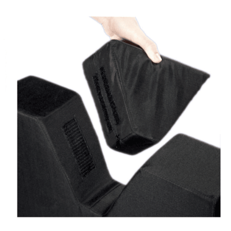 A hand lifting one of three black adjustable foam wedge support blocks against a plain white background. - okotoks hc pharmacy
