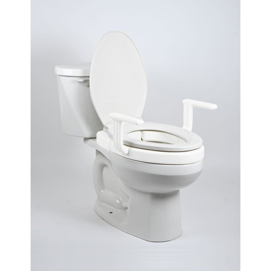 White toilet with a raised seat on a light gray background - okotoks hc pharmacy