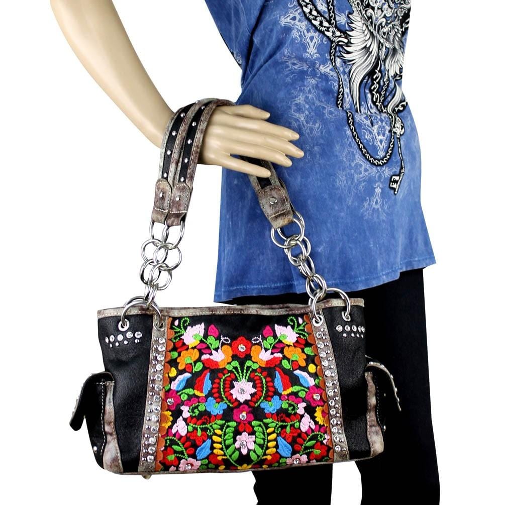 Colorful embroidered handbag held by a mannequin against a white background - okotoks hc pharmacy