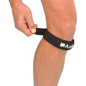Person wearing a black knee strap with a visible brand logo on a white background - Okotoks hc pharmacy