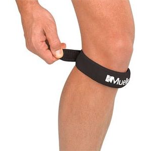 Person wearing a black knee strap with a visible brand logo on a white background - Okotoks hc pharmacy