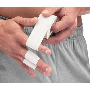 A close-up of a person wrapping white athletic tape around their fingers, wearing gray athletic shorts against a white background. - okotoks hc pharmacy
