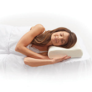 Woman lying on a white bed with a white pillow - Okotoks HC Pharmacy