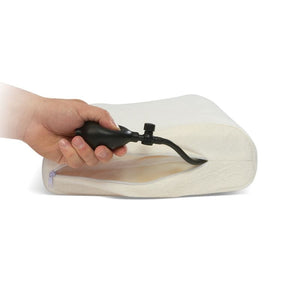 Hand using a pump to inflate a white air-filled cushion on a white background - Okotoks HC Pharmacy