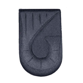 Black rectangular patch with a central circular design on a white background - okotoks hc pharmacy