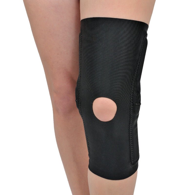 Black knee brace on a person's knee against a white background - okotoks hc pharmacy