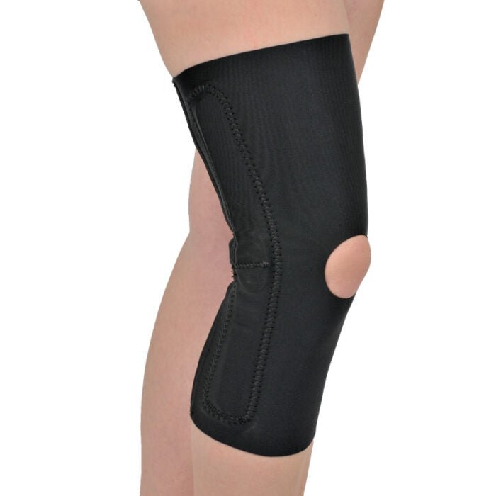 Black knee brace on a person's knee against a white background - okotoks hc pharmacy